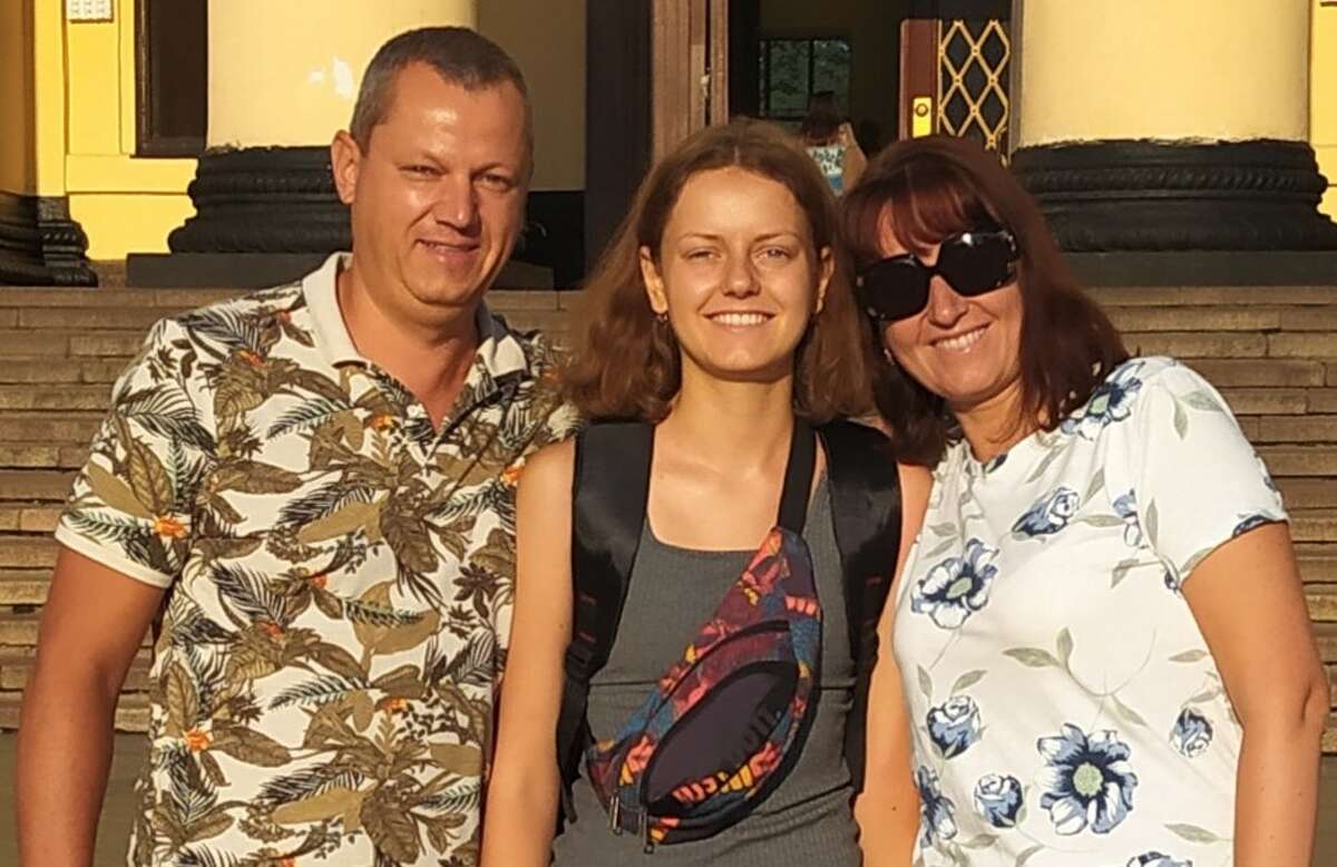 Kateryna "Katya" Savienkova (center) with her parents at a train station in Kharkiv, Ukraine, on the day she left for Jersey County. Her parents have fled Kharkiv for safety, and Savienkova is watching the unfolded war from Grafton.