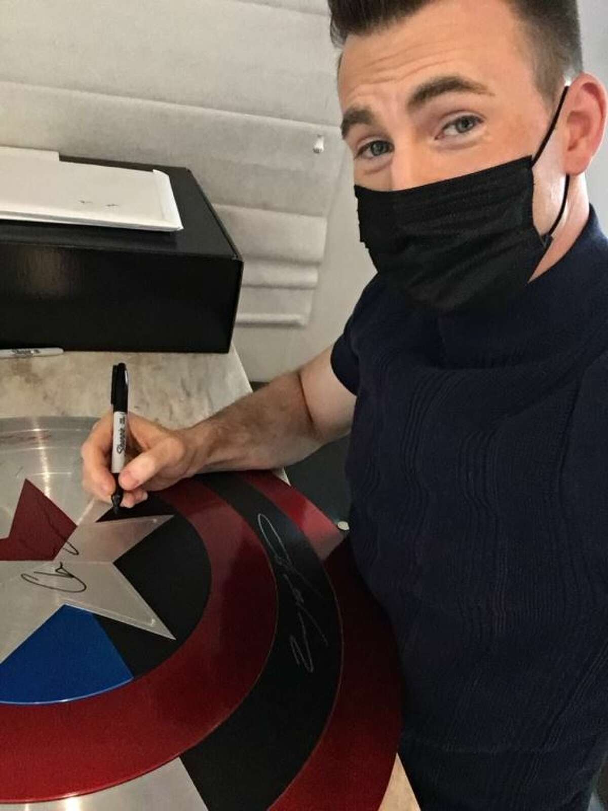 Actor Chris Evans, who plays the original Captain America in the Marvel Universe movies, was one of four actors to sign the shield.