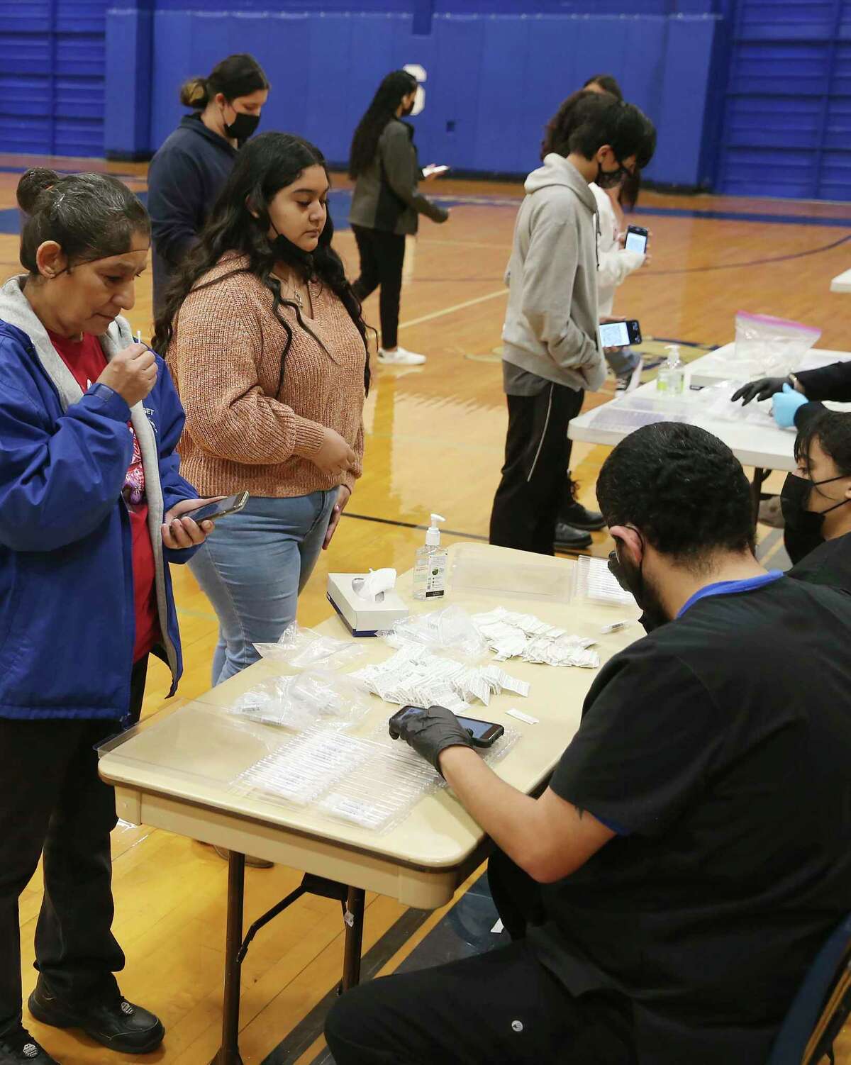 Somerset High School students and staff get their weekly COVID-19 testing at the school’s gym, Monday, Feb. 14, 2022. They are offered a weekly test on a voluntary basis.