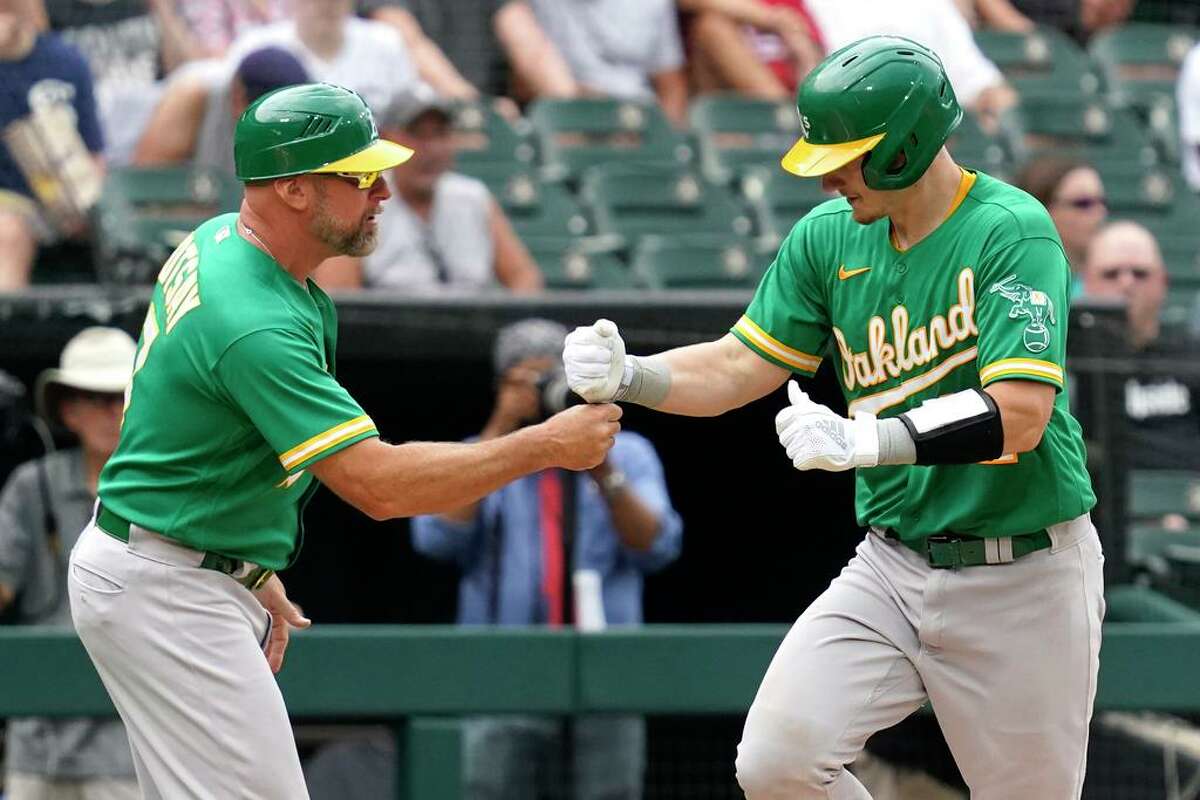 Oakland Athletics' Sean Murphy, right, celebrates with third base coach Mark Kotsay after hitting a solo home run during the third inning of a baseball game against the Chicago White Sox in Chicago, Thursday, Aug. 19, 2021. (AP Photo/Nam Y. Huh)