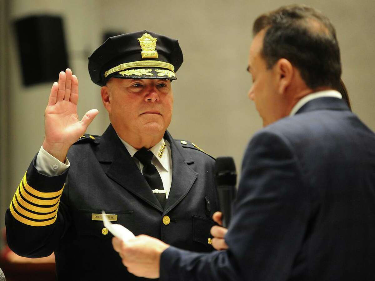 Armando "A.J." Perez is sworn in as Bridgeport police chief by Mayor Joseph Ganim in a ceremony at City Hall in Bridgeport, Conn. on Tuesday, November 13, 2018. Perez had been acting chief for two-and-a-half years.