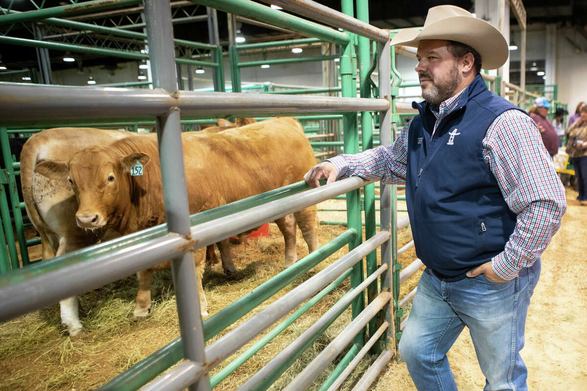Jimmy Sartwelle stands near the cattle pens in NRG Arena at the Houston Livestock Show and Rodeo Monday, March 7, 2022 in Houston.