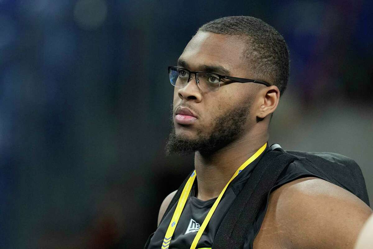 Alabama offensive lineman Evan Neal watches during the 40-yard dash at the NFL football scouting combine. Neal didn’t work out at the combine but will at Alabama’s pro day.