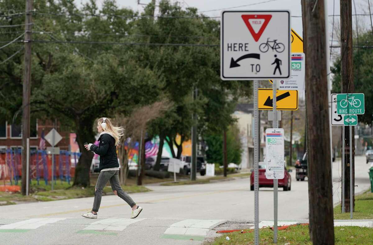 A woman crosses 11th Street at Nicholson along the Heights Hike and Bike Trail on Feb. 3, 2022 in Houston.