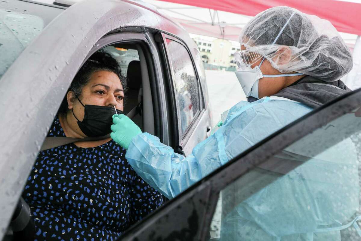 Medical assistant Griselda Salcido administers a coronavirus test to Maria Arrizon in Oakland in March.