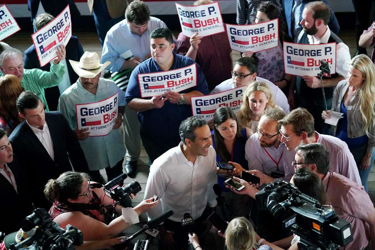 Texas Land Commissioner George P. Bush, center, talks with the media at a kick-off rally where he announced he will run for Texas Attorney General, June 2, 2021, in Austin, Texas.
