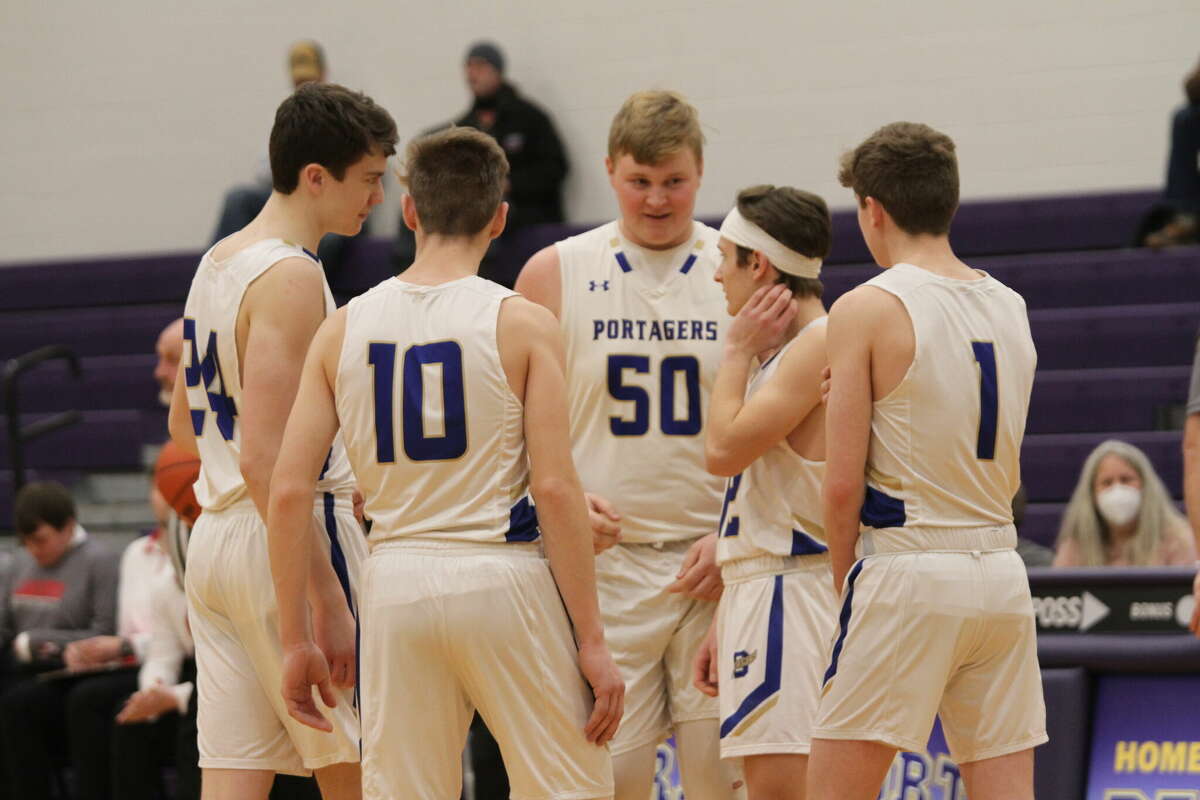 FILE - The Onekama basketball team huddles up before facing Bear Lake in the district opener. 