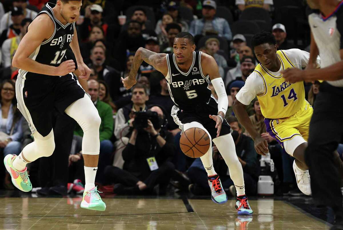 Spurs’ Dejounte Murray (5) gets a steal against Los Angeles Lakers’ Stanley Johnson (14) at the AT&T Center on Monday, March 7, 2022.