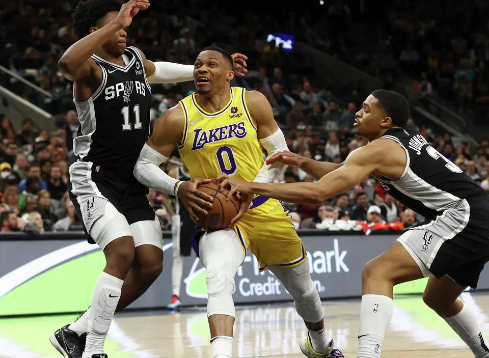 Russell Westbrook, center, then with the Los Angeles Lakers, competes against the Spurs in March 2022. In 2019, when he was with the Oklahoma City Thunder, Westbrook accused a fan of directing racial taunts at him. The fan was banned for life from NBA arenas.