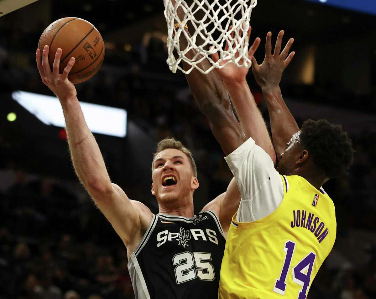 The Spurs’ Jakob Poeltl (25) attempts to score against the Lakers’ Stanley Johnson (14) in the first half at the AT&T Center on Monday, March 7, 2022.