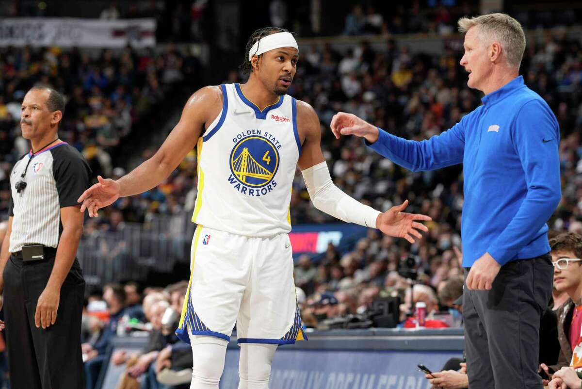 Golden State Warriors guard Moses Moody, left, confers with Golden State Warriors head coach Steve Kerr in the second half of an NBA basketball game against the Denver Nuggets Monday, March 7, 2022, in Denver. (AP Photo/David Zalubowski)
