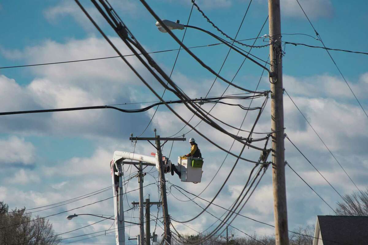 Crews with National Grid work to repair electrical lines along Guilderland Avenue on Tuesday, March 8, 2022, in Rotterdam, N.Y. Utility customers in New York are $1.7 billion behind on their gas and electric bill amid soaring price inflation.
