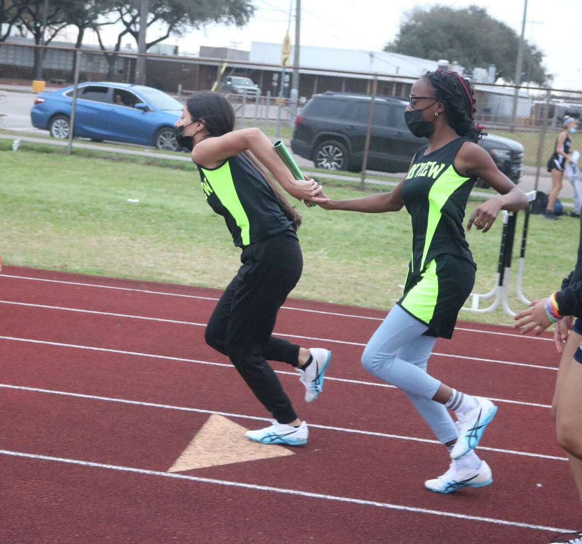 A Park View pair completes the last handoff during the 4 by 200 relay race Monday night. The team secured the bronze medal in 2:07.61.