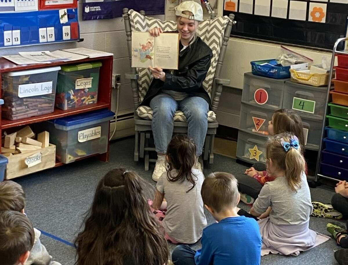 Manistee High School student Sarah Huber, dressed as Mike Teavee, reads to students at Jefferson Elementary School in Manistee to kick off National Reading Month.