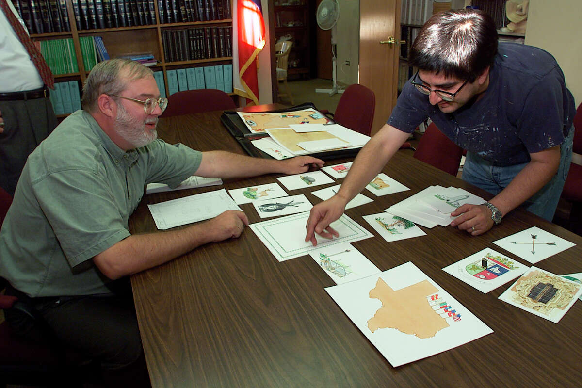 Bexar County Clerk Gerry Rickhoff and artist Andy Benavides look over design ideas for the upcoming, updated Bexar County marriage license on Friday, October 22, 1999. The new license reflects various icons from around the county such as the Alamo, armadillo and Fort Sam Houston to name a few.