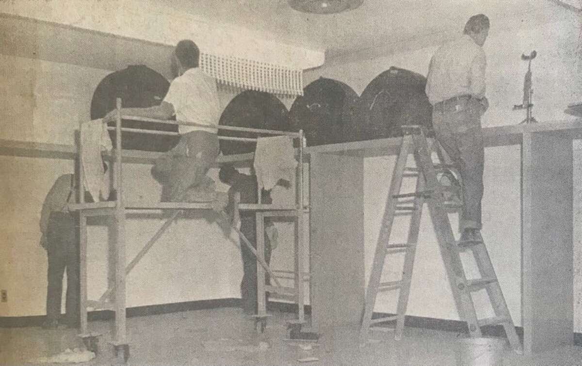 From left, Melvin Smith, William Cark, William Herr and Charles Pressnell clean walls, ceilings, lights and floors in the band room at the new Midland High School on Eastlawn Avenue.  August 1957