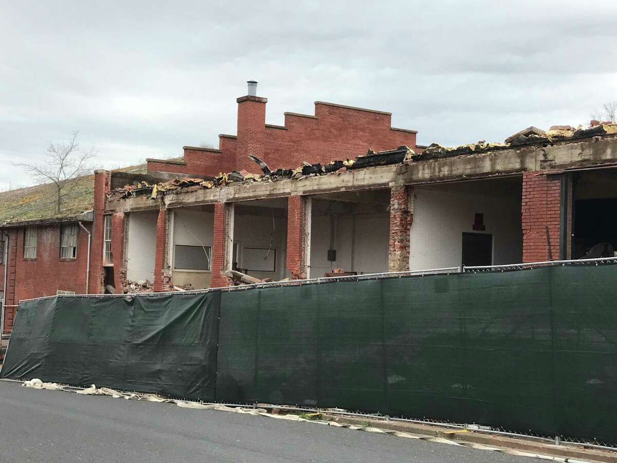A portion of an abandoned Texas Department of Criminal Justice warehouse is being demolished in Huntsville on March 7, 2022.