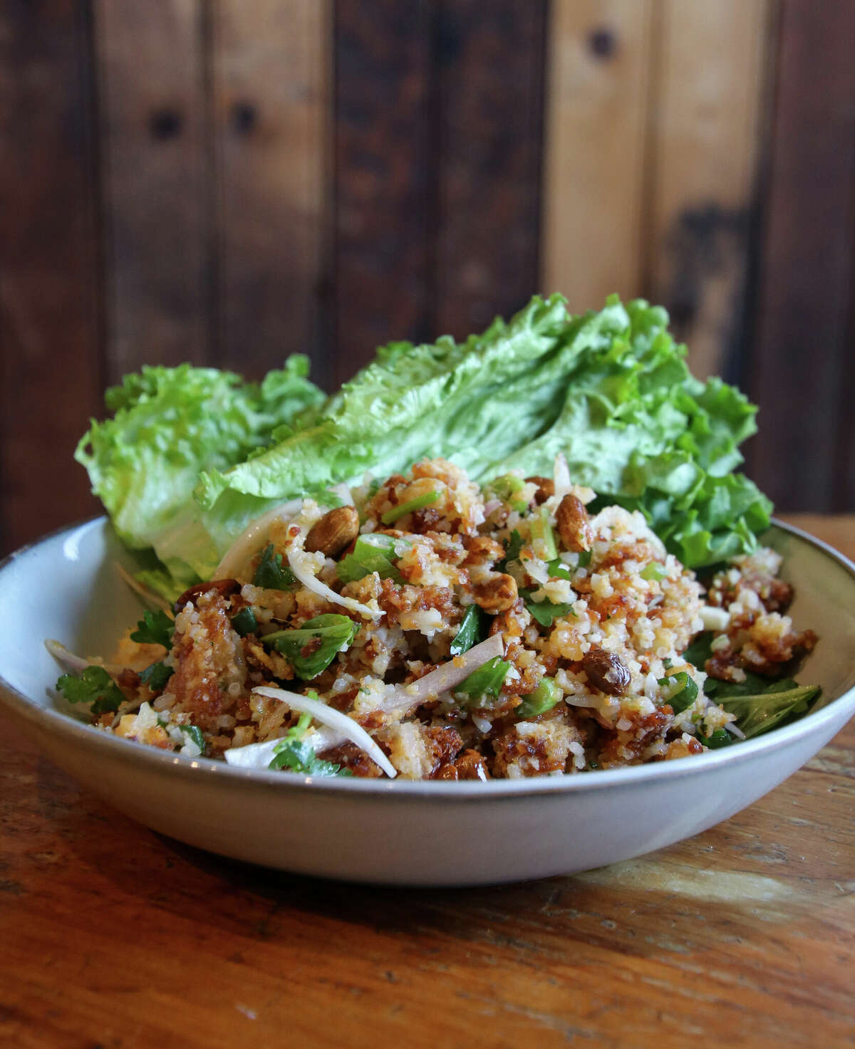 On the menu at Haan Lao at Bound by Fate in Schuylerville is naem khao, lettuce wraps with crispy coconut rice, fish sauce-lime dressing, peanuts and herbs.