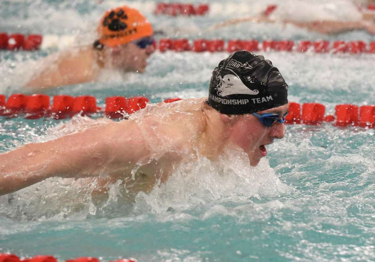 Darien's Thomas Dupont completes in the 100 butterfly during the FCIAC boys swimming finals in Greenwich on Thursday, March 3, 2022.