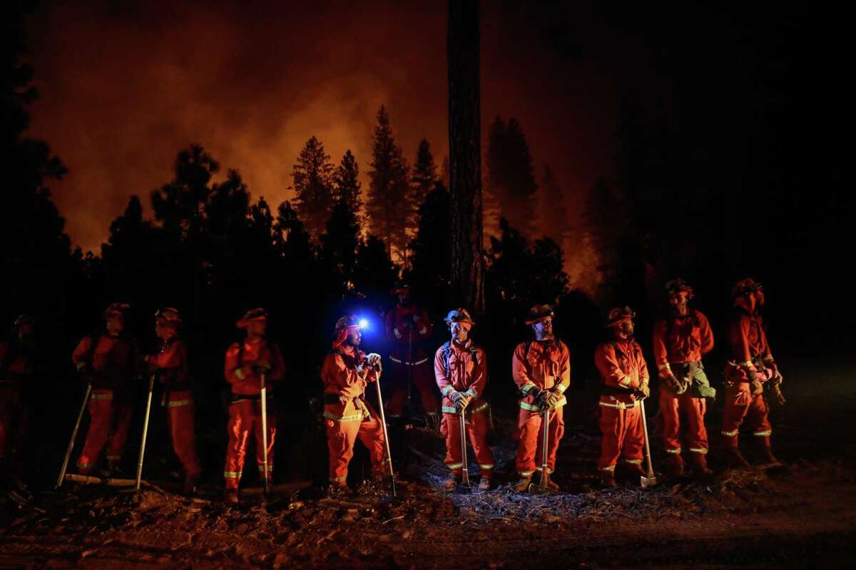 Valley View inmate firefighters wait for instructions before a back burn operation on the North Complex Fire in Butte County on Sept. 13, 2020.
