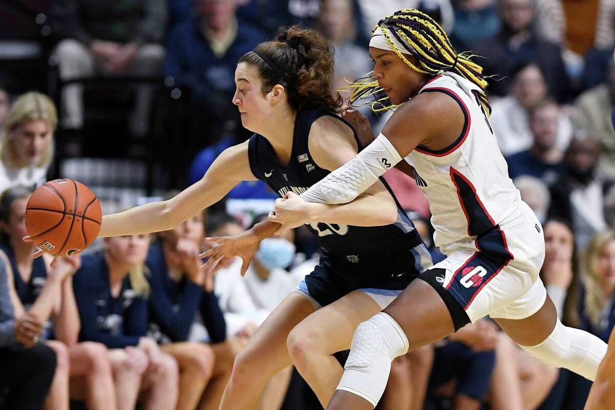 Villanova's Maddy Siegrist, left, is pressured by Connecticut's Aaliyah Edwards in the second half of an NCAA college basketball game in the Big East tournament finals at Mohegan Sun Arena, Monday, March 7, 2022, in Uncasville, Conn. (AP Photo/Jessica Hill)