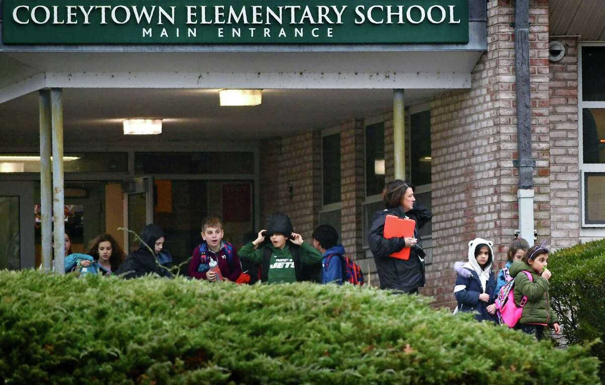 Students leave Coleytown Elementary School Thursday, February 13, 2020, in Westport, Conn. The Westport Board of Education voted on moving strat time later in the day.
