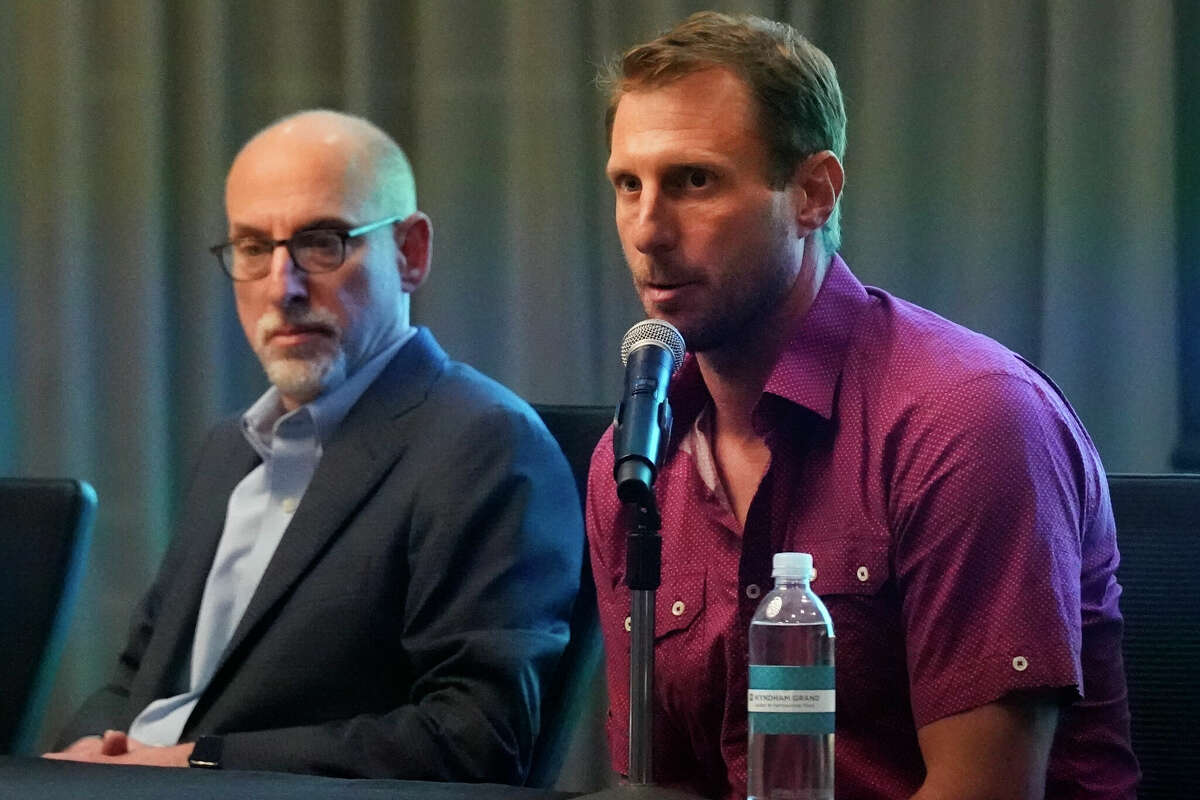 New York Mets pitcher Max Scherzer, right, speaks as Bruce Meyer, chief union negotiator, listens during a news conference Tuesday, March 1, 2022, in Jupiter, Fla. Major League Baseball has canceled opening day. Commissioner Rob Manfred announced Tuesday the sport will lose regular-season games over a labor dispute for the first time in 27 years after acrimonious lockout talks collapsed in the hours before management's deadline. (AP Photo/Wilfredo Lee)