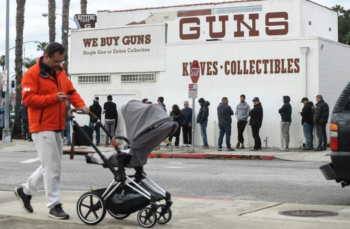 People stand in line outside a gun store on March 15, 2020 in Culver City, California. A Ninth Circuit court panel ruled in January that Ventura County acted illegally by closing gun shops at the outset of the pandemic, but a majority of the court’s judges voted to set the ruling aside and reconsider the issue.
