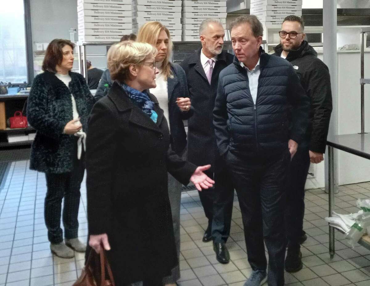 Gov. Ned Lamont visited Vinny's Pizza & Italian Restaurant in Torrington Tuesday morning to learn how the owners plan to use a second brownfields remediation grant to transform another portion of its old factory building into a banquet hall for weddings and other events. The Seferi family converted a portion of the building on East Elm Street into a restaurant in 2019. The former Vinny's was on East Main Street. Mayor Elinor Carbone, left, led a tour of the restaurant including its large kitchen.