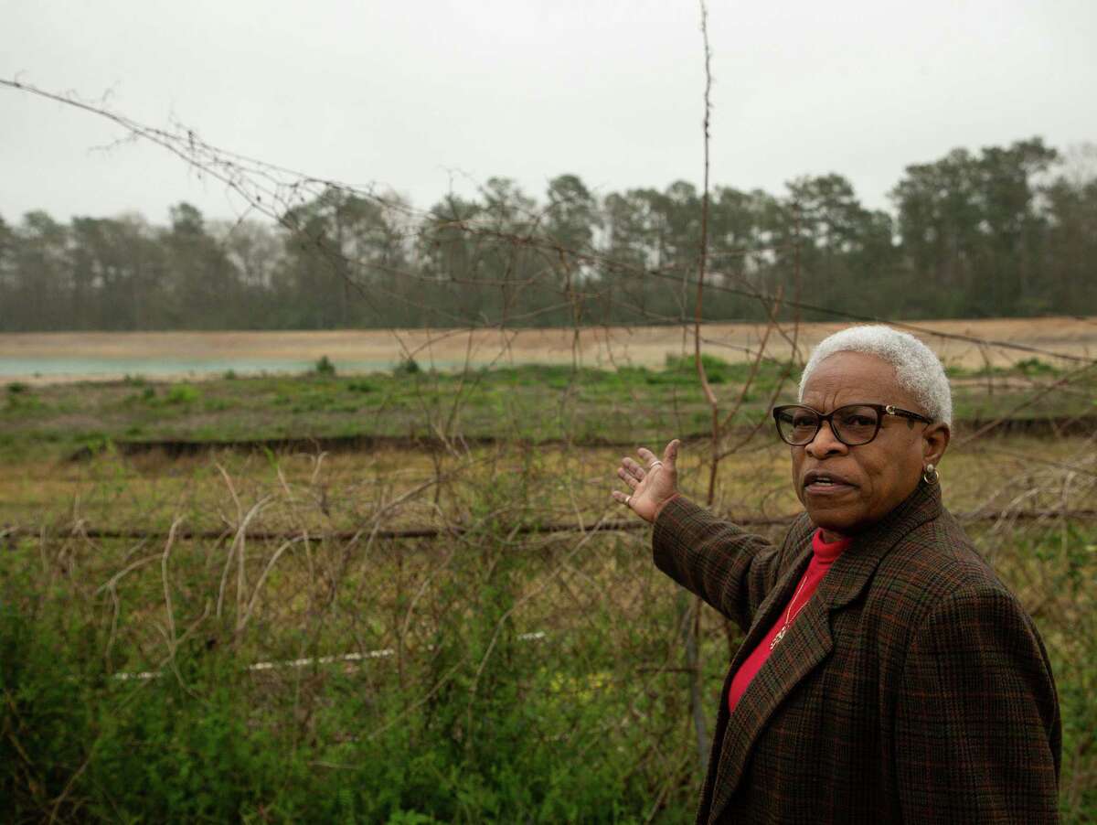 Doris Brown, who filed a civil rights complaint with HUD about GLO's distribution of Harvey mitigation funds, points to a retention pond which was recently built behind the neighborhood, on Tuesday, March 8, 2022, in Houston. That complaint resulted in a finding Tuesday that the GLO discriminated against communities of color, which could redirect millions in funds to Houston.