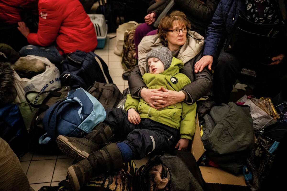 Refugees from Ukraine rest at the train station in Przemysl, Poland on Sunday, March 6, 2022. About half of the more than two million refugees fleeing the war in Ukraine are children, according to UNICEF. (Erin Schaff/The New York Times)