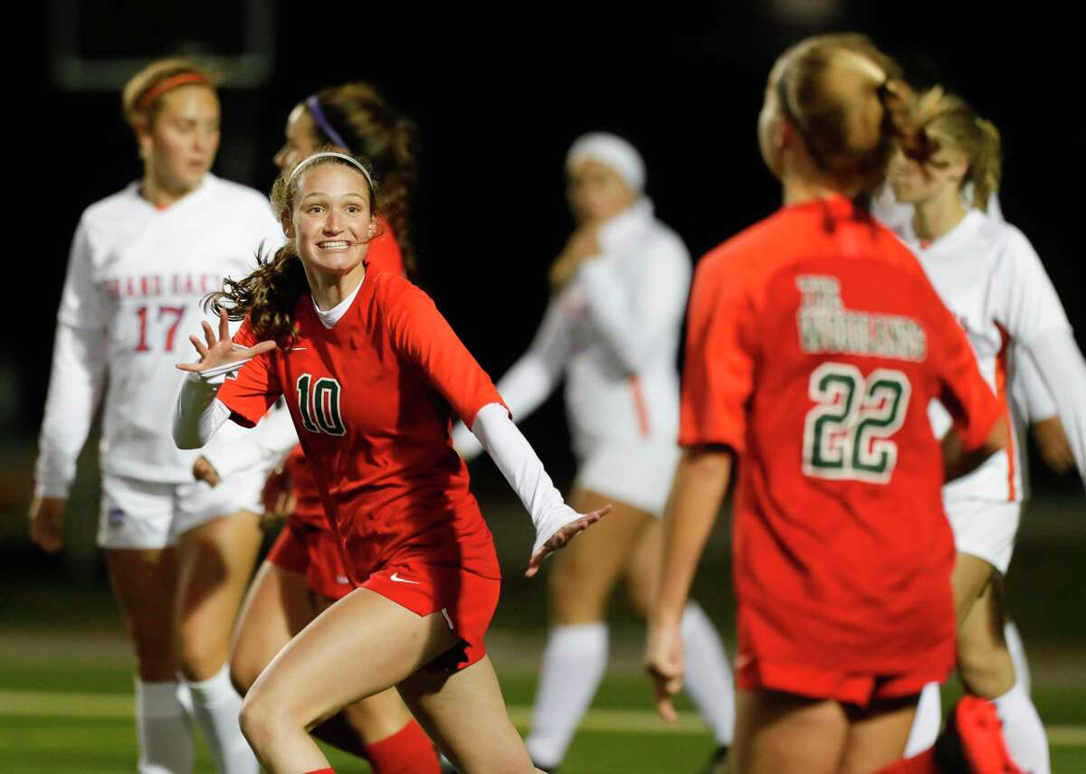 The Woodlands' Caroline White (10) turns after a goal by Savannah Knight to tie the match 1-1 in the second period of a District 13-6A high school soccer match at Woodforest Bank Stadium, Tuesday, March 8, 2022, in Shenandoah.