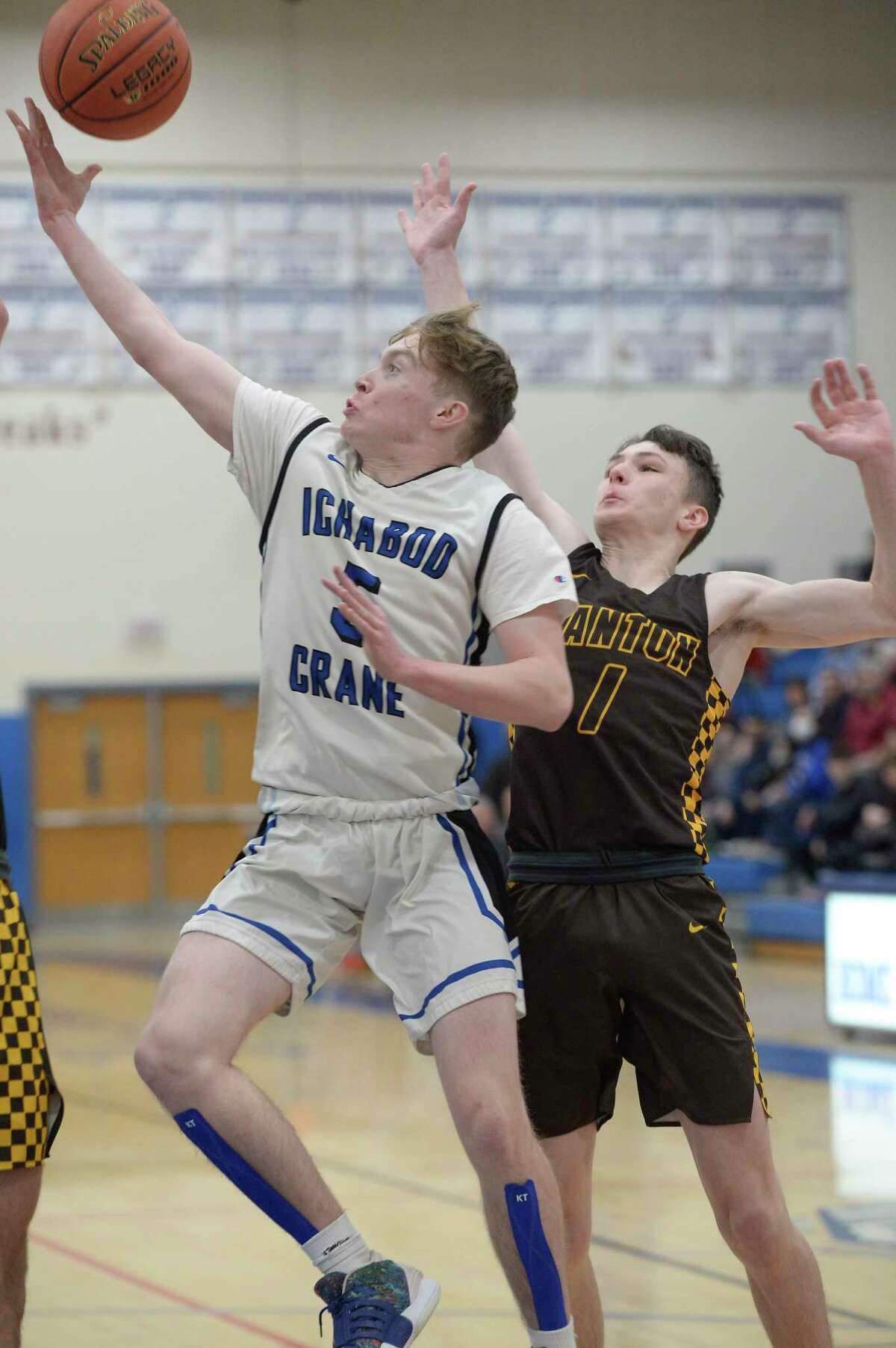 Ichabod Crane's Alex Schmidt maneuvers past Canton's Luke Wentworth for a shot on the hoop during their Class B state sub-regional on Tuesday, Mar. 8, 2022, in Saratoga Springs, N.Y. (Jenn March, Special to the Times Union)