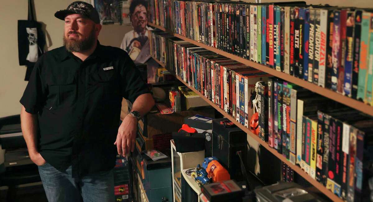 Drilling engineer Jason Dyer talks about his VHS tape collection at his home. Dyer has more than 3,000 tapes and also cleans and repairs VCRs.