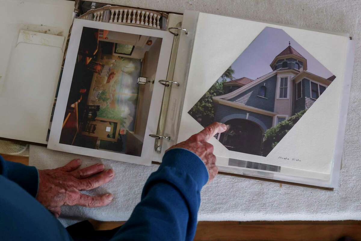 Jim Smith points out a photo of a home in Monte Vista he consulted with.