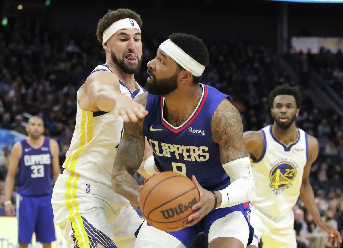 Klay Thompson (11) defends against Marcus Morris Sr. (8) during the first half as the Golden State Warriors played the Los Angeles Clippers at Chase Center in San Francisco, Calif., on Tuesday, March 8, 2022.