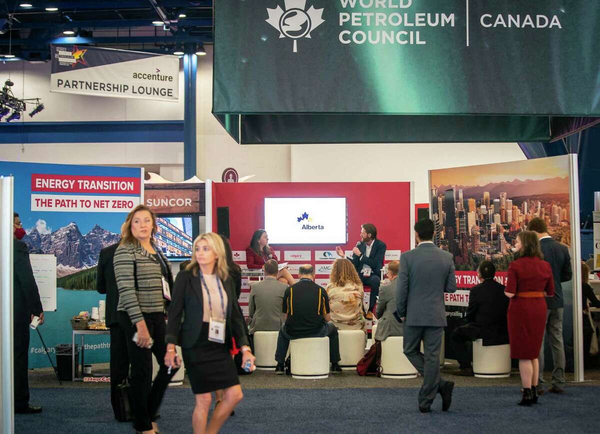 People walk through the exhibition hall during the first day of the World Petroleum Congress on Monday, Dec. 6, 2021, at the George R Brown Convention Center in Houston.
