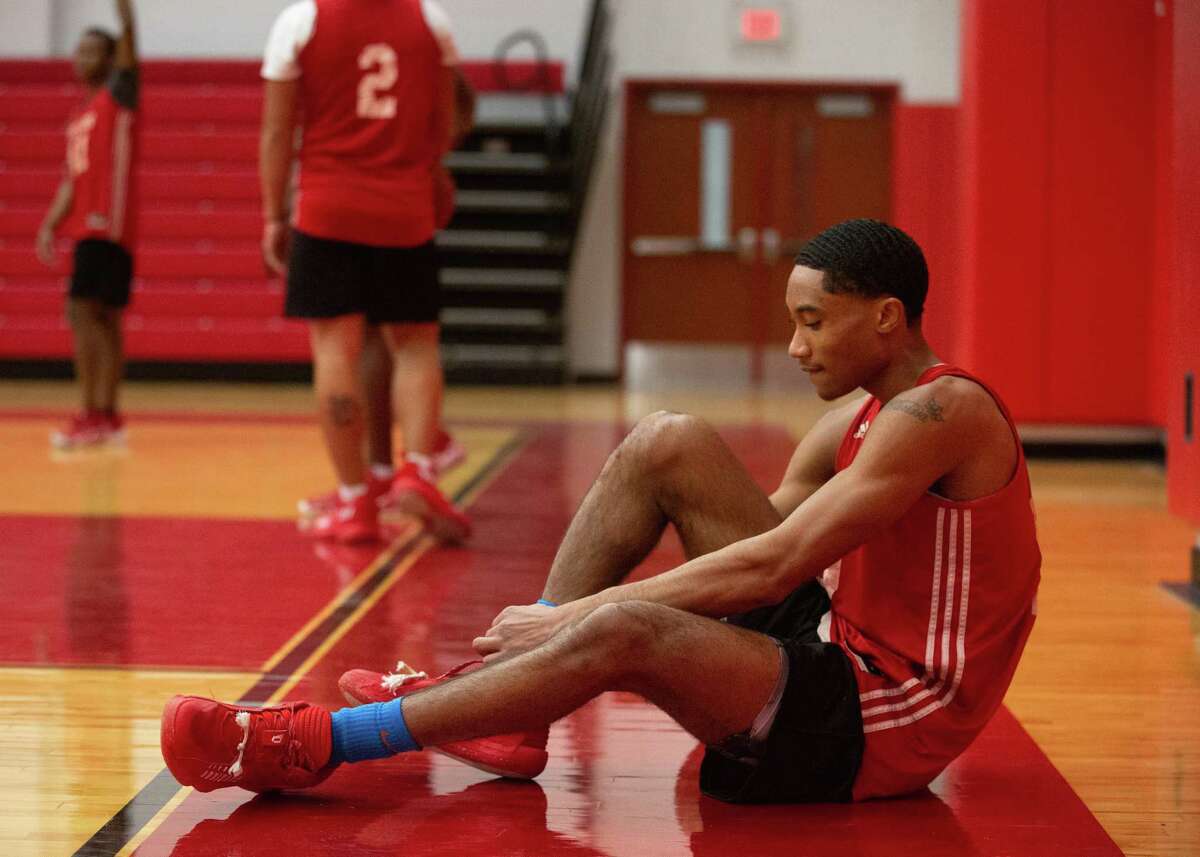 Hitchcock High School boys basketball player A’Aderius Blanks ties his shoes during practice as the team is preparing for state tournament Tuesday, March 8, 2022, in Hitchcock.