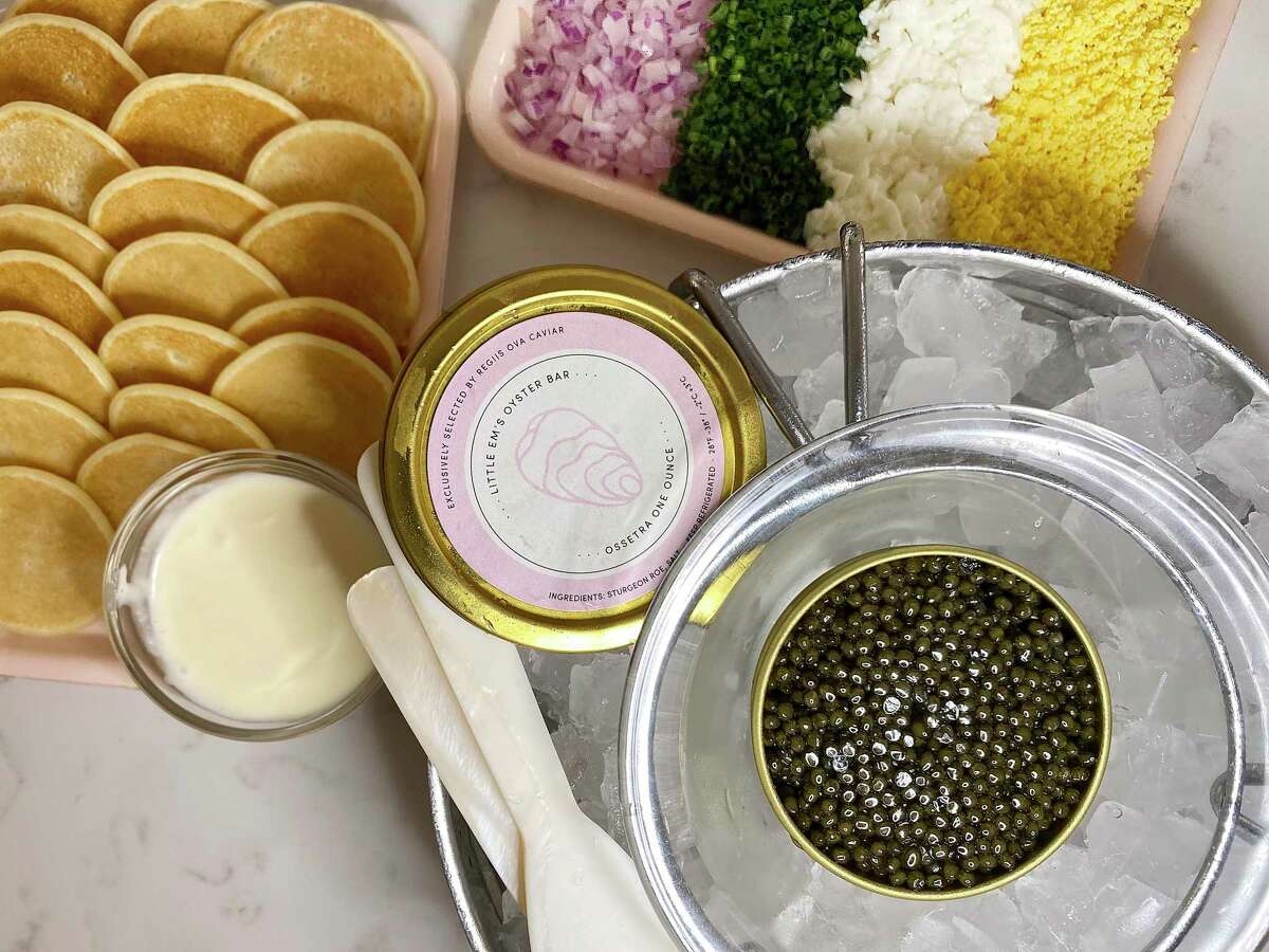 Caviar service at Little Em's Oyster Bar includes blini, crème fraîche and a tray of chopped red onions, chives and boiled egg.