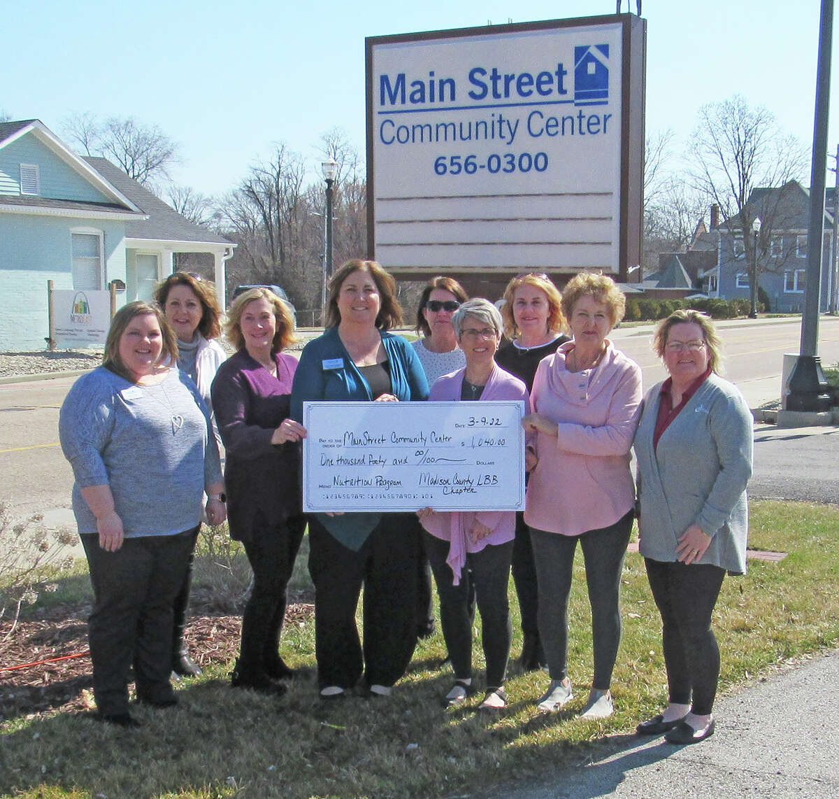 Employees of Main Street Community Center and members of the Madison County chapter of Little Black Book gather outside the center to celebrate Little Black Book’s donation of $1,040 for Main Street’s nutrition program. Front row left to right, Annie Eads, Sara Berkbigler, Valerie Morrisey, Marilyn Schaecher and Lisa Webb. Back row left to right, Teresa Reiniger, Beth Behrhorst, Kimberly Hunt and Brenda Moore.