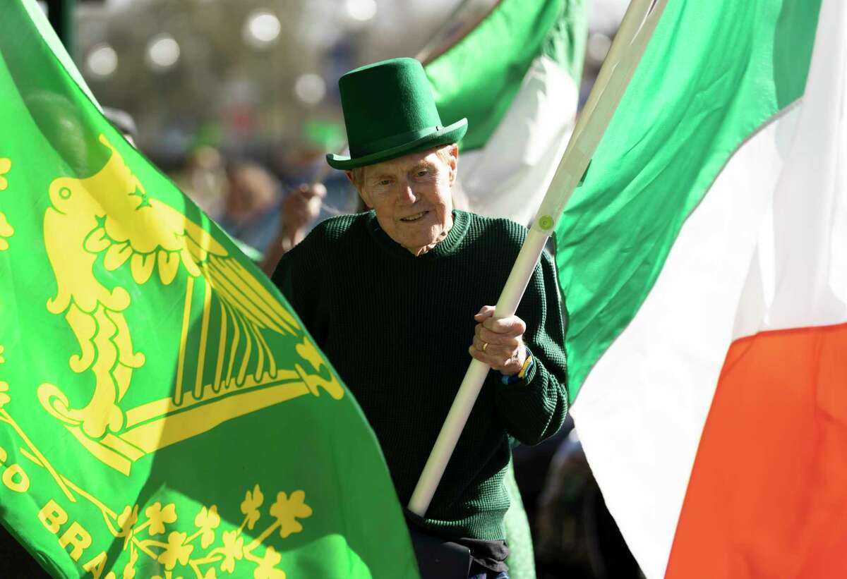 Michael McDougal holds an Irish flag while leading a parade during the Pat Green and David Anderson Memorial St Patrick’s Day Parade, Wednesday, March 17, 2021, in downtown Conroe. The parade was on a hiatus for the past two years but brought back inviting local community members to participate.