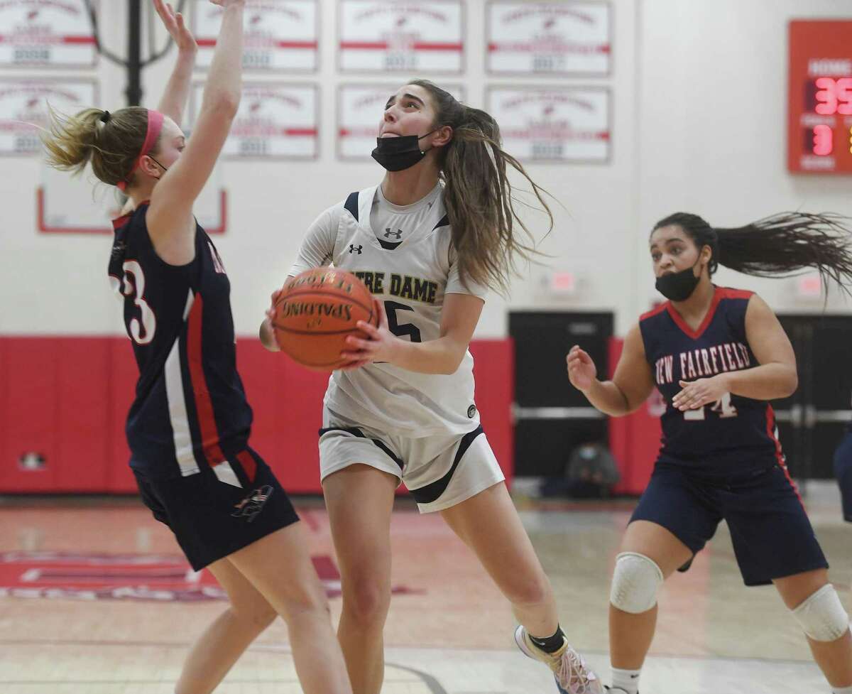 Notre Dame of Fairfield's Sarah Macary drives to the basket defended by New Fairfield's Kelly Ford during the Lancers' victory in the SWC girls basketball championship at Pomperaug High School in Southbury, Conn. on Thursday, February 24, 2022.