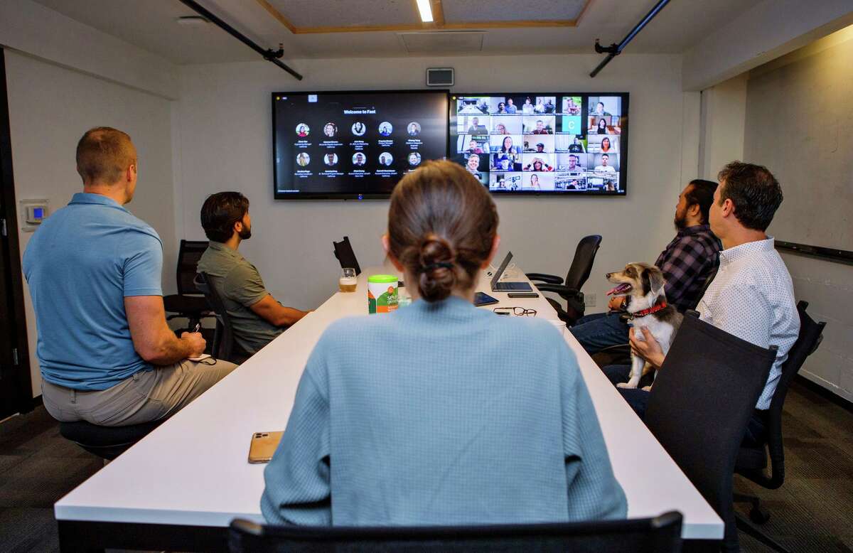 Employees listen to new team member presentations at the Fast office in San Francisco in October. A new survey suggests businesses want their employees in the office a set number of days a week.