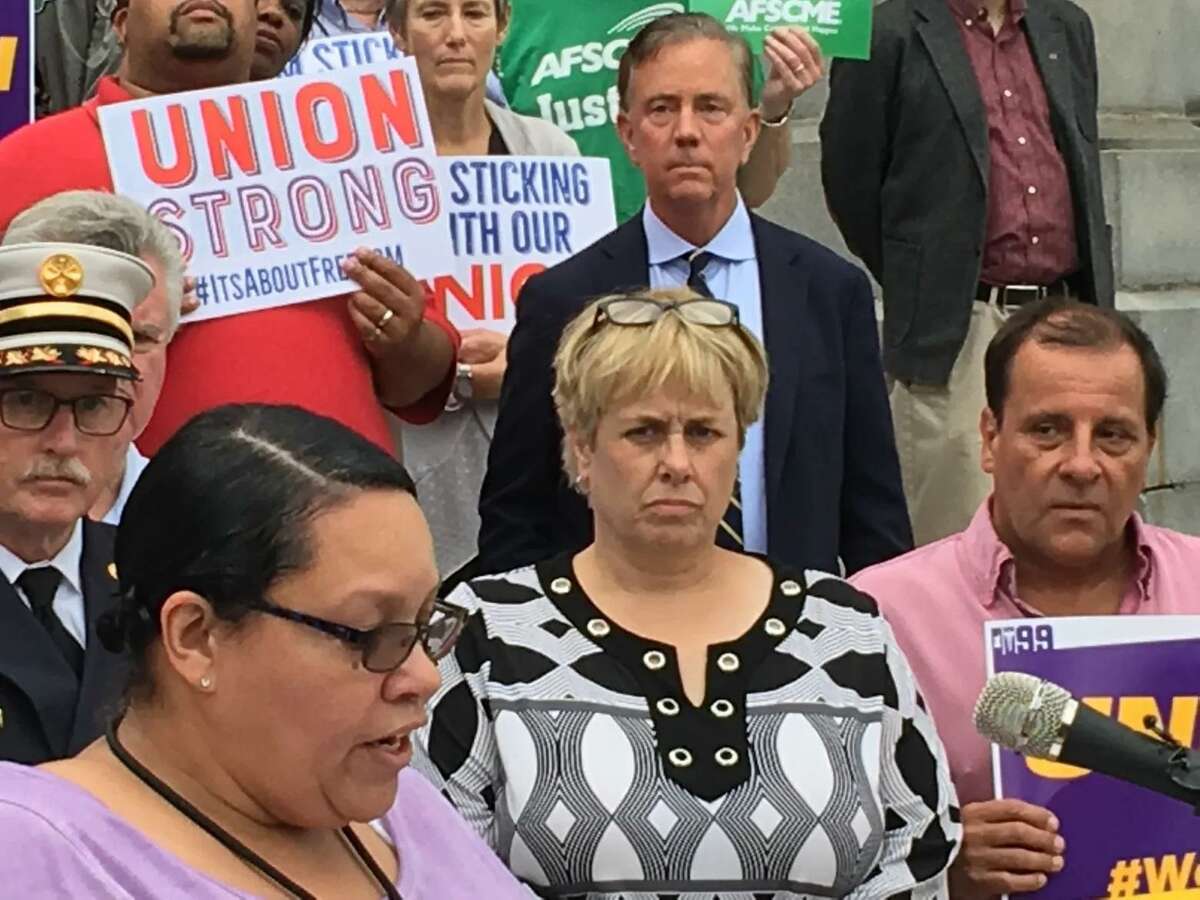 Democratic gubernatorial candidate Ned Lamont stands behind Lori J. Pelletier at a union rally in 2018.