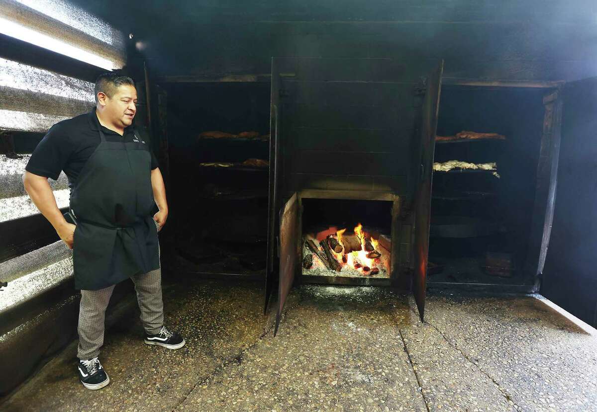 Adrian Davila of Davila's BBQ in Seguin shows his smoke pit, which is fired by wood, but having a natural gas outage still has affected the way he prepares his food for patrons.