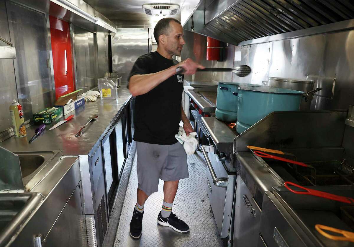 El Ranchito's Robby De La Garza cooks food in his food truck, which uses propane gas, as the city of Seguin deals with a natural gas outage that could last for days.