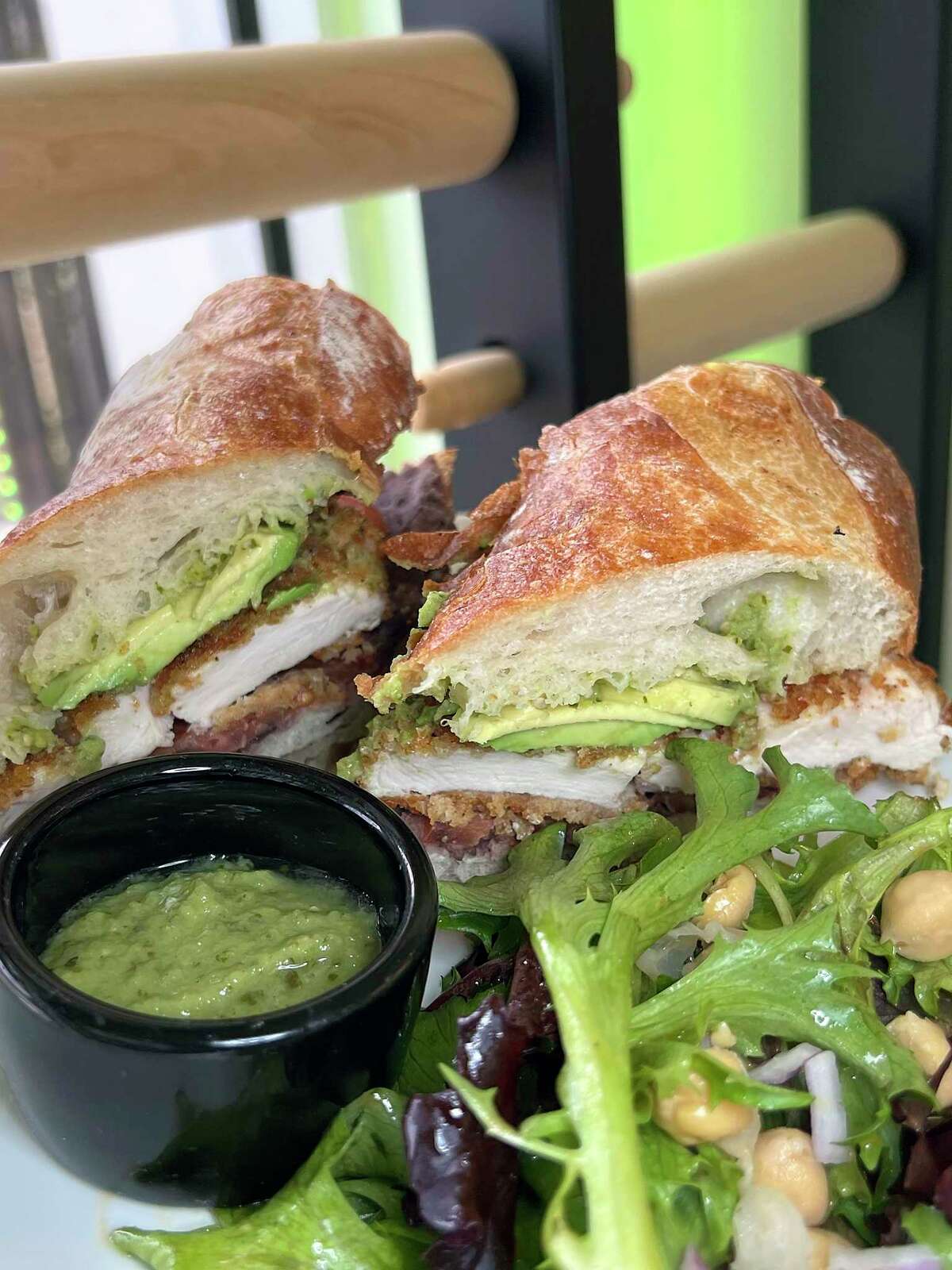 A chicken milanesa torta includes breaded chicken breast, avocado and refried beans on a fresh baguette at Pan & Coffee, a bakery, sandwich shop and coffee shop in Stone Oak.
