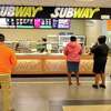 Customers wait for food at Subway at the 1-95 northbound rest plaza in Milford, Conn., on Mar. 2, 2020. The Milford-headquartered Subway’s international presence includes 446 restaurants in Russia.