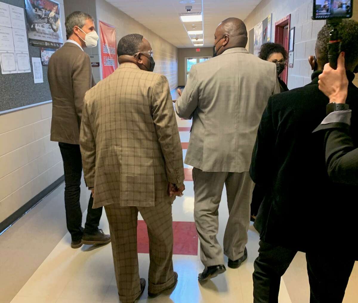 Beto O'Rourke, left, Port Arthur Mayor Thurman "Bill" Bartie and Career and Technology Educational Director Kevin Johnson walk through the halls of Memorial High School. Photo taken March 9, 2022. Olivia Malick/The Enterprise