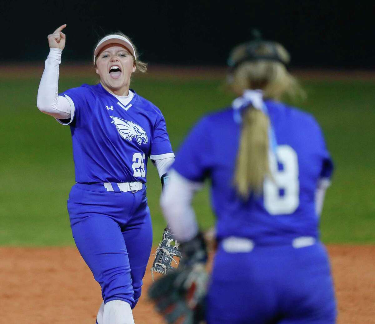 New Caney second baseman Mckenna Rinewalt (25) cheers on starting pitcher Skylar Scott after a strikeout during the second inning of a high school softball game at Lake Creek High School, Wednesday, March 9, 2022, in Montgomery.